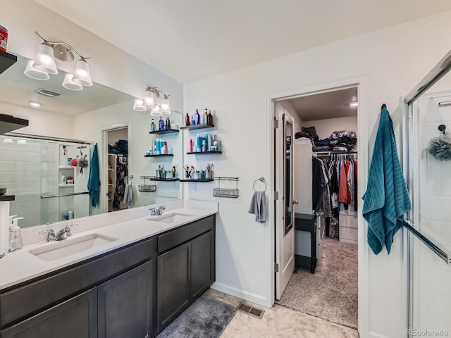 bathroom featuring vanity and an enclosed shower