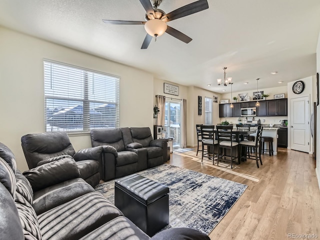 2300 Mountain Sky Dr, Fort Lupton, CO 80621 - living area with a chandelier, light wood-style flooring, ceiling fan, and recessed lighting