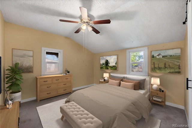 carpeted bedroom with vaulted ceiling, ceiling fan, and a textured ceiling