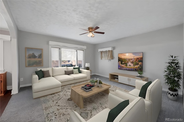 living room with ceiling fan and a textured ceiling