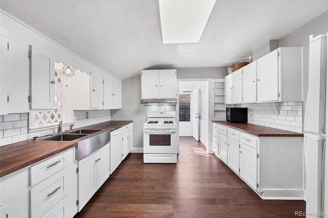 kitchen with butcher block countertops, tasteful backsplash, white cabinets, dark wood-type flooring, and white appliances