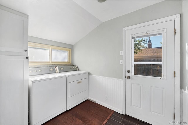 washroom featuring dark wood-type flooring, independent washer and dryer, and a healthy amount of sunlight