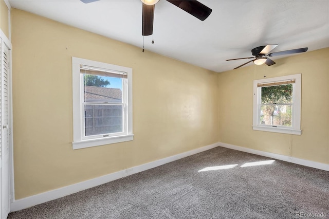 carpeted empty room featuring ceiling fan