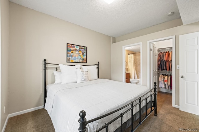7452 Singing Hills Dr, Boulder, CO 80301 - bedroom with carpet floors, a walk in closet, a closet, baseboards, and a textured ceiling