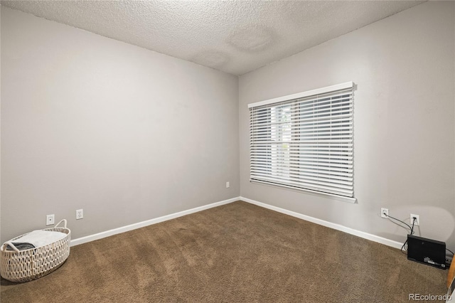 7452 Singing Hills Dr, Boulder, CO 80301 - spare room with dark carpet, a textured ceiling, and baseboards
