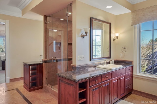 bathroom featuring recessed lighting, vanity, baseboards, ornamental molding, and a shower stall