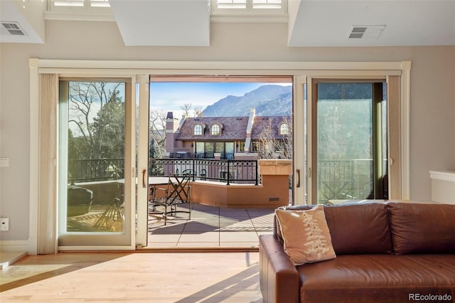 entryway with visible vents, a mountain view, and wood finished floors