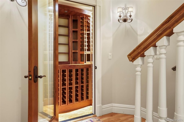 wine room with baseboards and wood finished floors