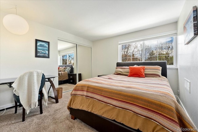 bedroom with carpet flooring, baseboards, and a closet