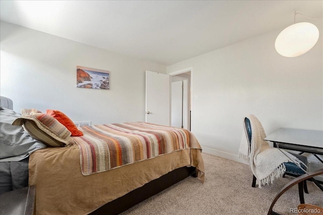 bedroom featuring baseboards and carpet