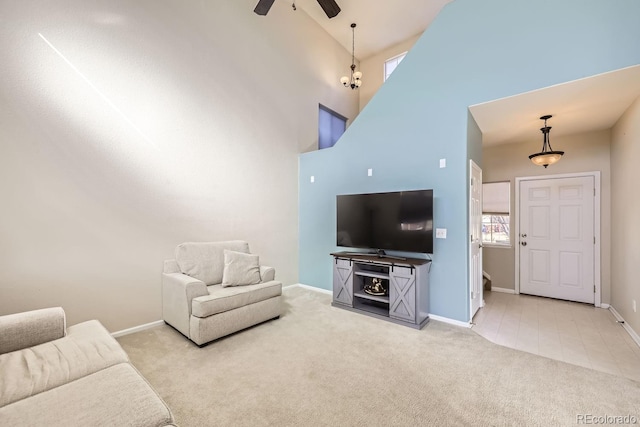 carpeted living room with ceiling fan and a towering ceiling