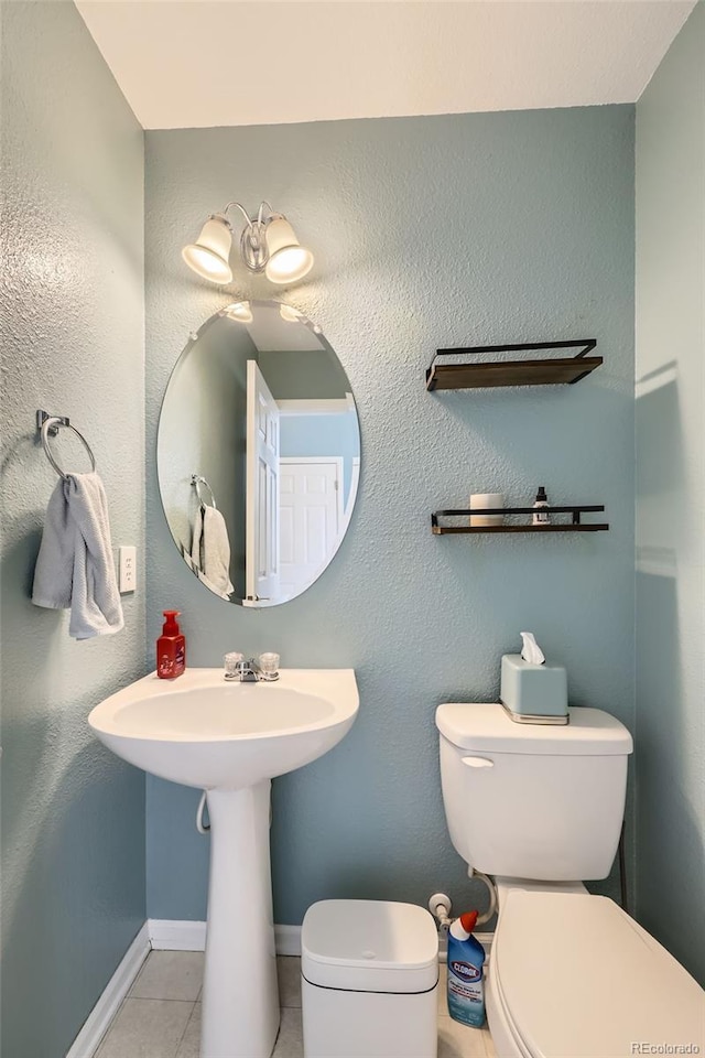 bathroom with toilet and tile patterned floors