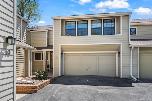 1011 Pierce St Unit 11, Lakewood, CO 80214 - multi unit property featuring a garage, driveway, and roof with shingles