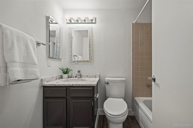 1011 Pierce St Unit 11, Lakewood, CO 80214 - full bathroom featuring toilet, vanity, wood finished floors, bathing tub / shower combination, and baseboards