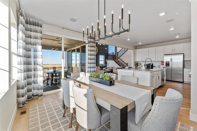 dining space featuring sink and light hardwood / wood-style floors