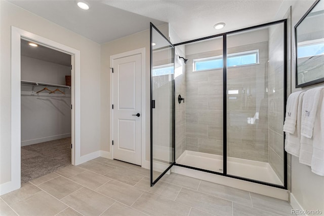 bathroom featuring a shower with door