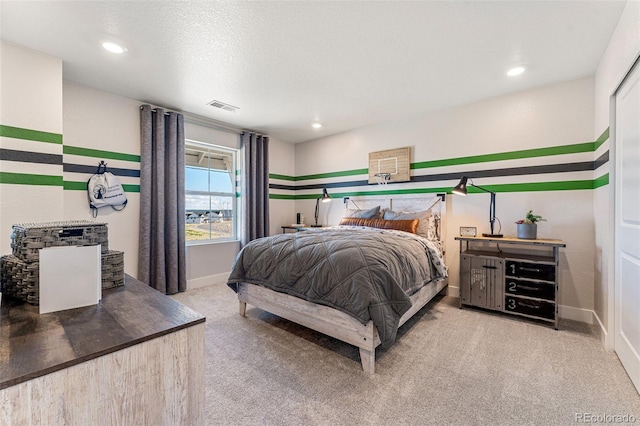 carpeted bedroom featuring a textured ceiling