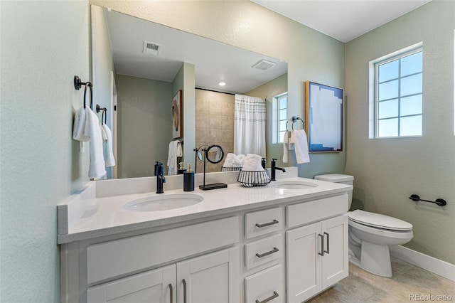 bathroom featuring vanity, toilet, and walk in shower