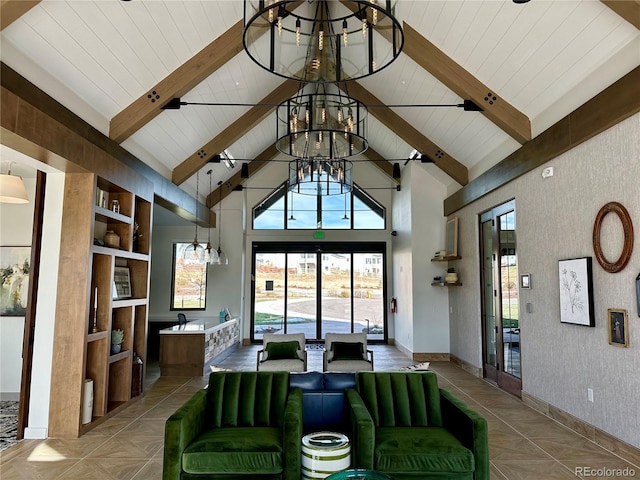 living room with light parquet floors, beamed ceiling, high vaulted ceiling, and a chandelier