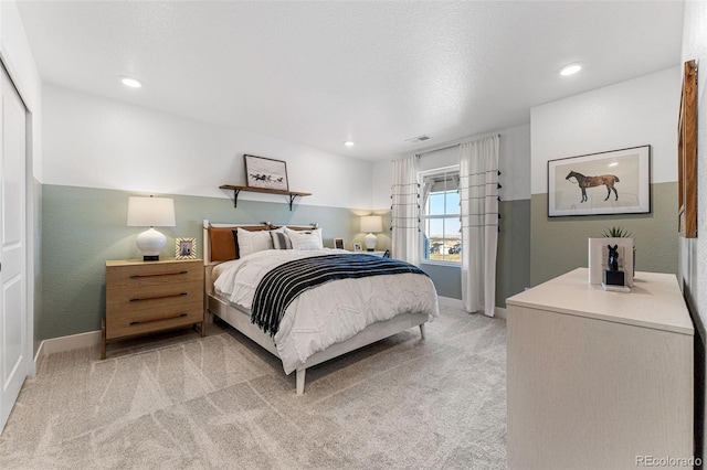 carpeted bedroom with a textured ceiling