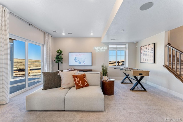 carpeted living room featuring a textured ceiling