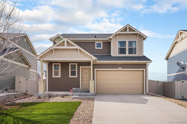 craftsman-style house with an attached garage, board and batten siding, driveway, and fence
