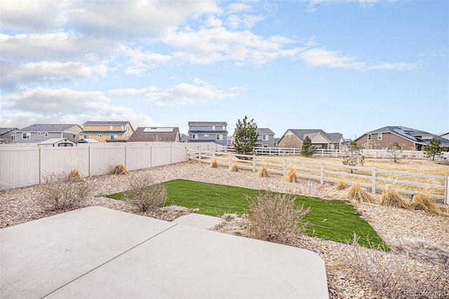 view of yard with a patio, a residential view, and a fenced backyard