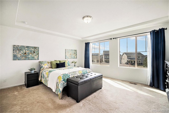 bedroom featuring light carpet and baseboards