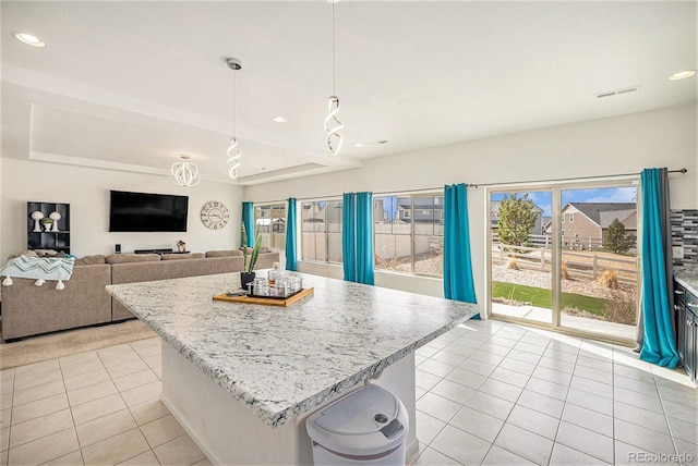 kitchen featuring recessed lighting, light tile patterned floors, a center island, visible vents, and pendant lighting