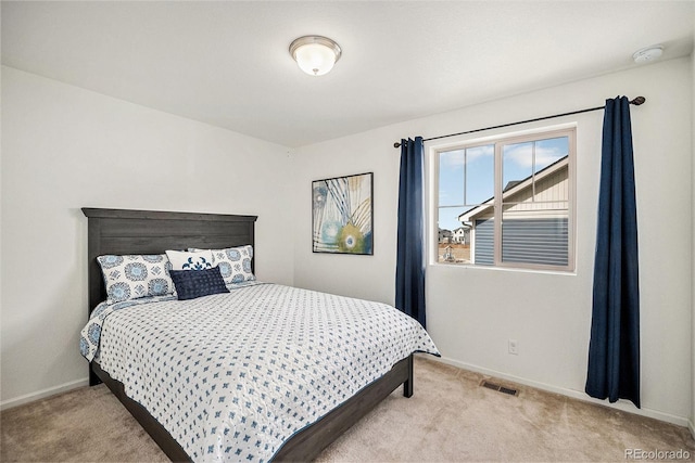 carpeted bedroom with baseboards and visible vents