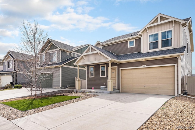 craftsman-style house featuring an attached garage, a shingled roof, board and batten siding, and concrete driveway