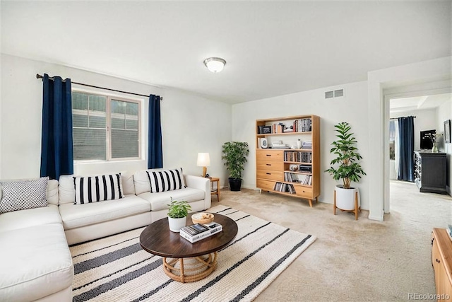 living room featuring light colored carpet and visible vents