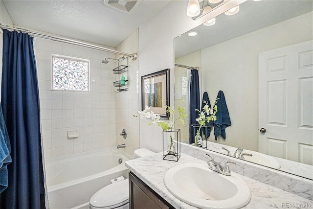 full bath with shower / bath combo with shower curtain, vanity, and toilet