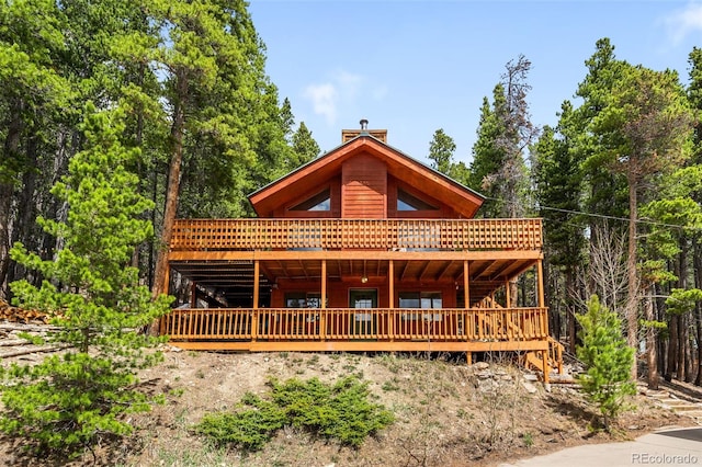 489 Harris Dr, Idaho Springs, CO 80452 - view of front of house featuring a wooden deck and a chimney