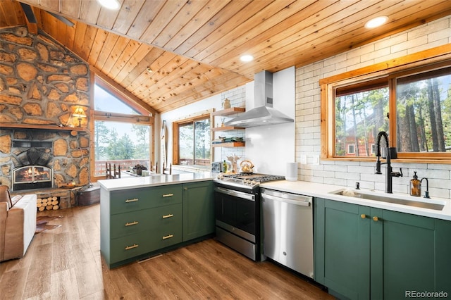 489 Harris Dr, Idaho Springs, CO 80452 - kitchen with green cabinetry, stainless steel appliances, wall chimney range hood, a sink, and wooden ceiling