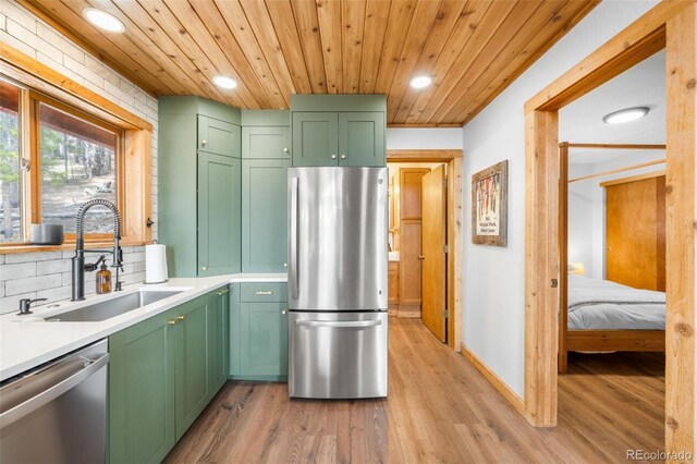 489 Harris Dr, Idaho Springs, CO 80452 - kitchen with stainless steel appliances, green cabinetry, a sink, recessed lighting, and light wood-style floors