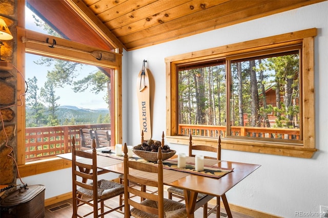 489 Harris Dr, Idaho Springs, CO 80452 - dining room featuring plenty of natural light, a mountain view, lofted ceiling, baseboards, and wooden ceiling