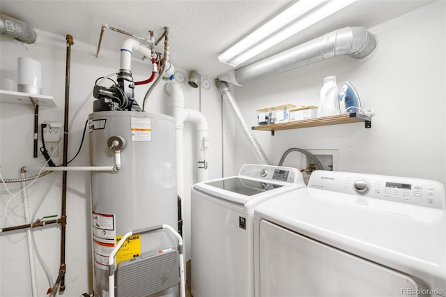 489 Harris Dr, Idaho Springs, CO 80452 - washroom with gas water heater, washer and clothes dryer, and a textured ceiling