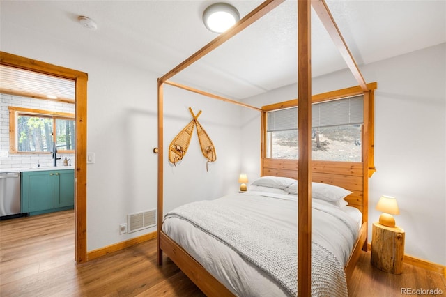 489 Harris Dr, Idaho Springs, CO 80452 - bedroom featuring light wood-style flooring, baseboards, and a sink