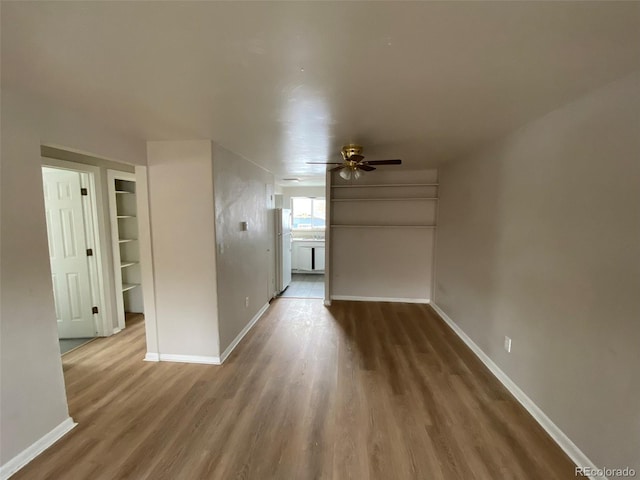 unfurnished living room with hardwood / wood-style floors and ceiling fan