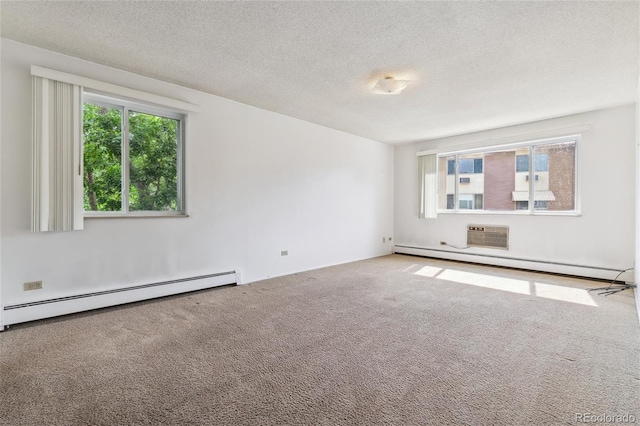 spare room featuring a baseboard heating unit, a textured ceiling, and carpet flooring