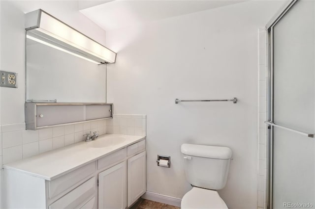 bathroom with tasteful backsplash, vanity, toilet, and an enclosed shower