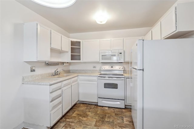 kitchen with sink, white cabinets, and white appliances