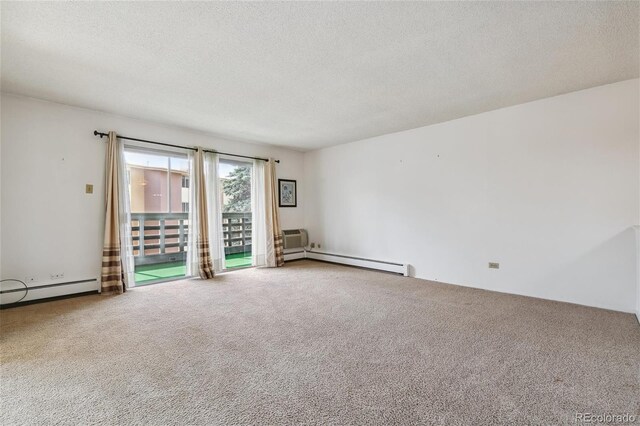 empty room with a textured ceiling, carpet, and a baseboard heating unit