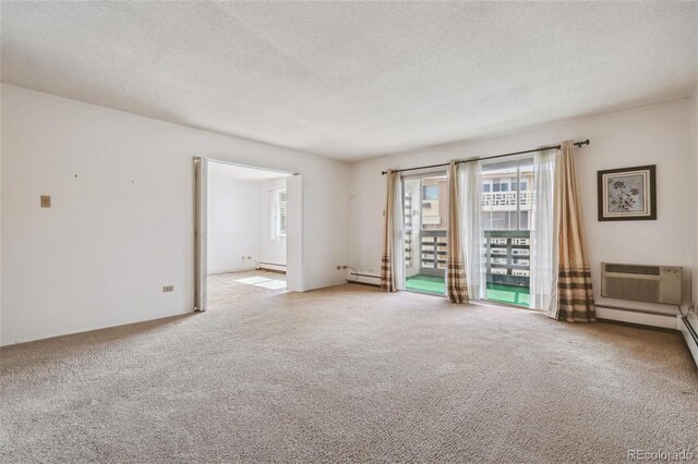 unfurnished room with a baseboard heating unit, light colored carpet, a wall unit AC, and a textured ceiling