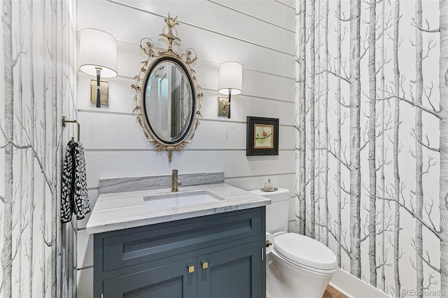 bathroom featuring vanity, toilet, and curtained shower