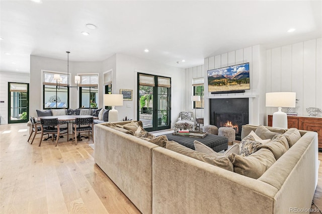 living room featuring a notable chandelier and light hardwood / wood-style flooring