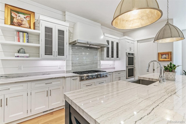 kitchen featuring pendant lighting, white cabinets, and custom exhaust hood