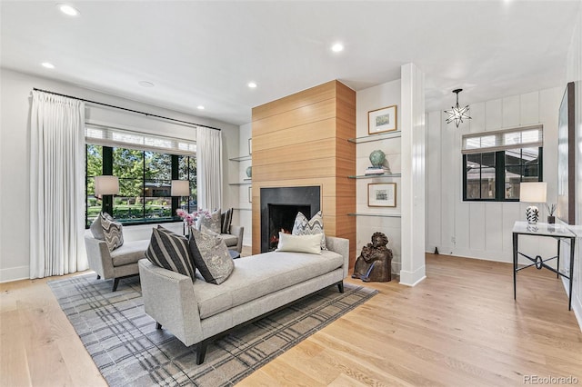 living room with a fireplace and light hardwood / wood-style flooring