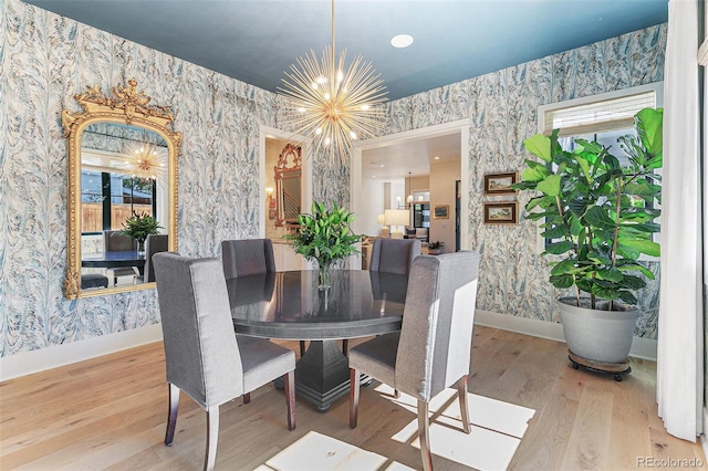 dining area featuring a notable chandelier, a wealth of natural light, and hardwood / wood-style flooring